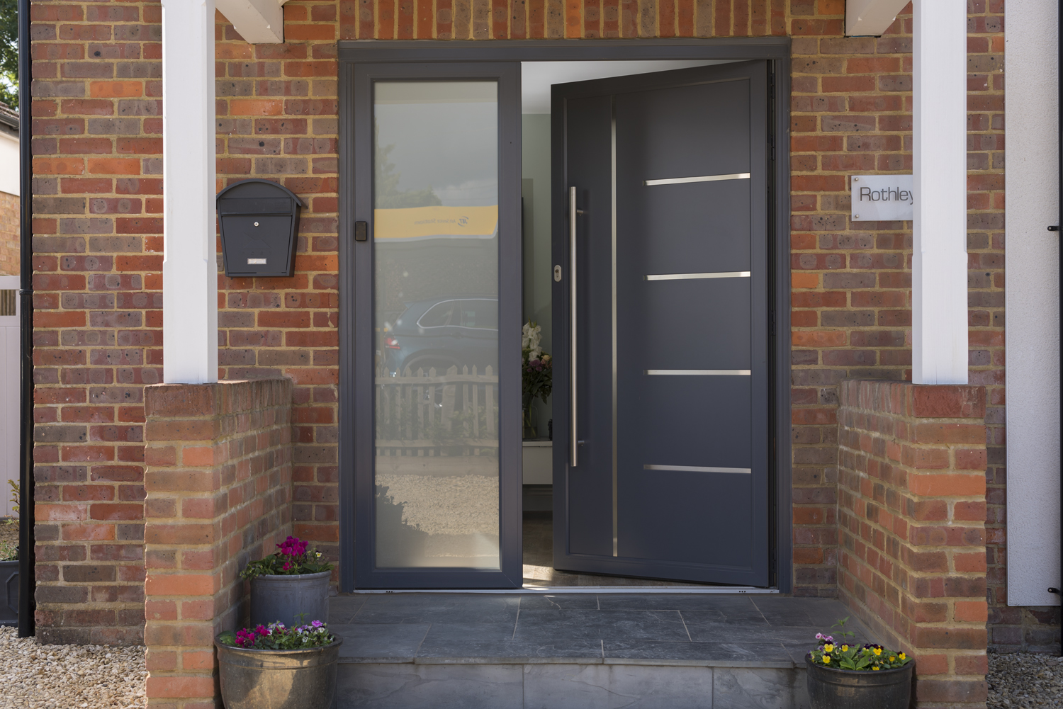 Origin aluminium front door in a contemporary UK home entrance
